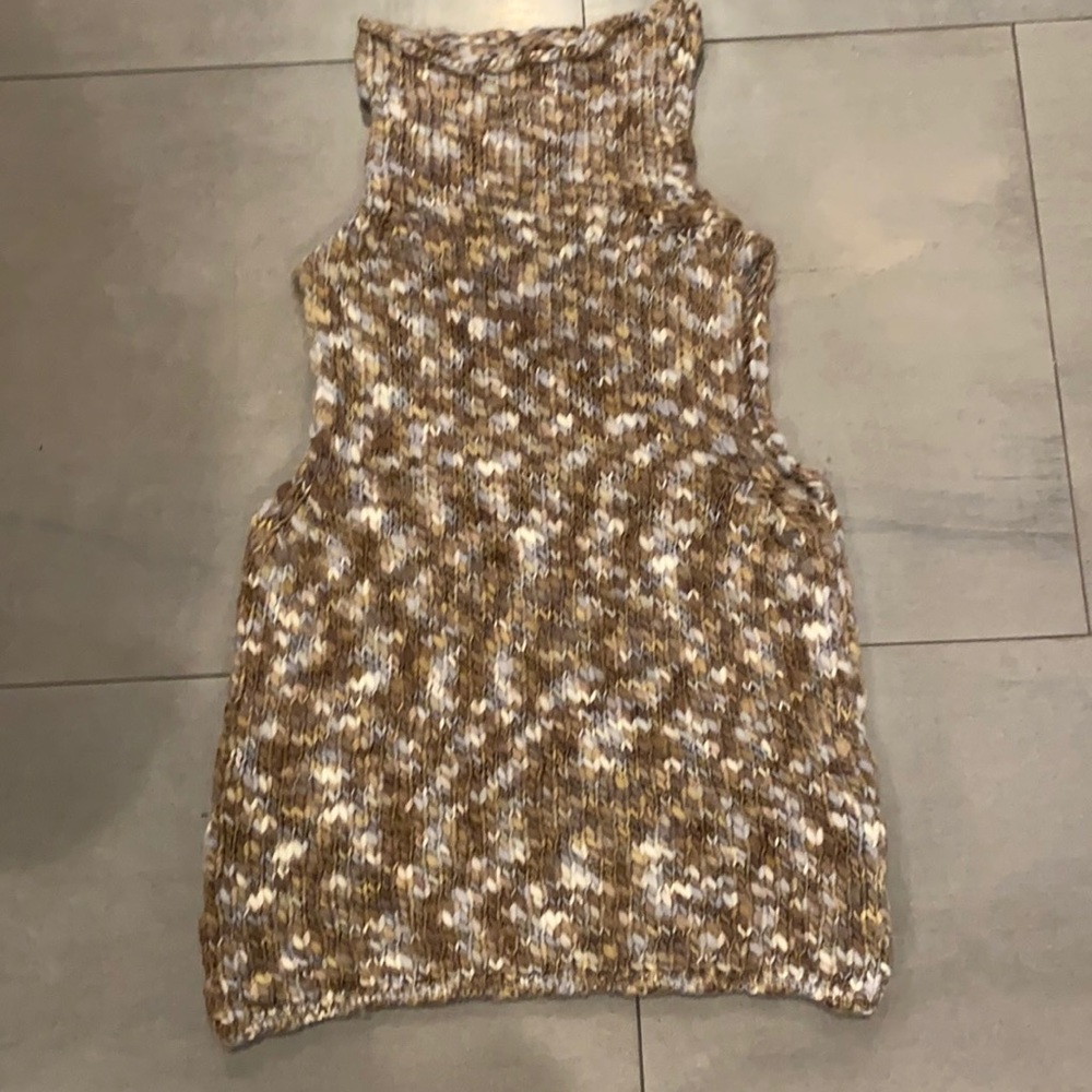 Sweater vest, turtleneck by Maurizio Pecoraro.